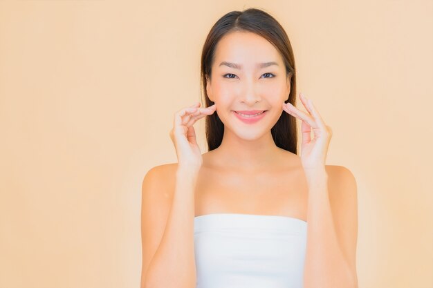 Portrait beautiful young asian woman in spa with natural makeup on beige