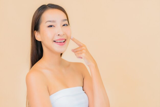 Portrait beautiful young asian woman in spa with natural makeup on beige