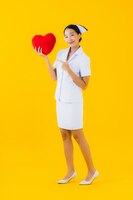 Free photo portrait beautiful young asian woman thai nurse with heart pillow shape