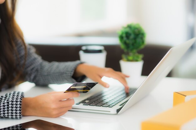 Portrait beautiful young asian woman use credit card with laptop for online shopping