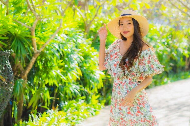 Portrait beautiful young asian woman walking with happy around outdoor garden view