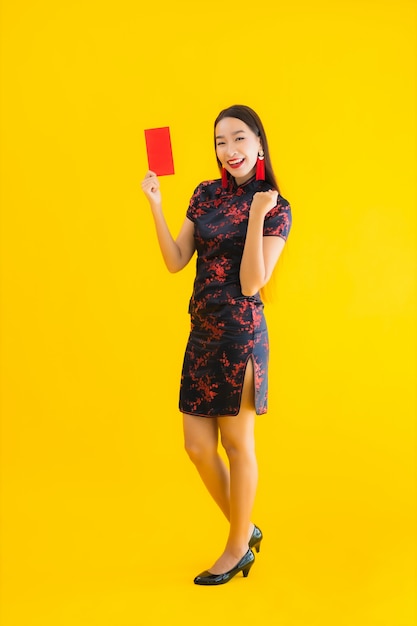 Portrait beautiful young asian woman wear chinese dress with Ang Pao or red letter with cash