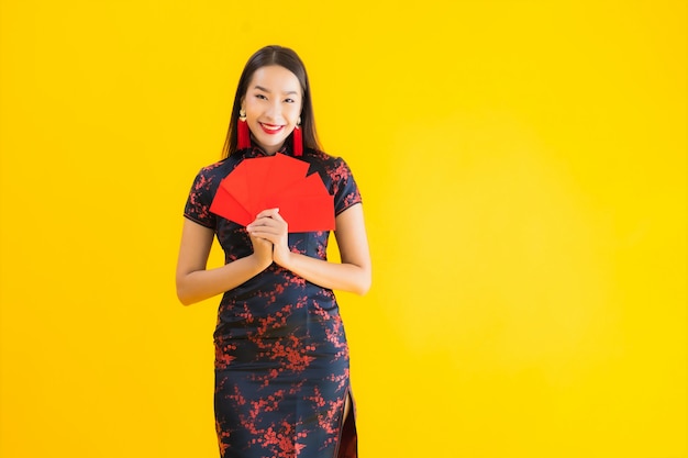 Portrait beautiful young asian woman wear chinese dress with ang pao or red letter with cash