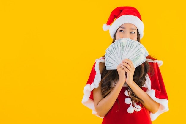 Portrait beautiful young asian woman wear christmas clothes and hat with cash