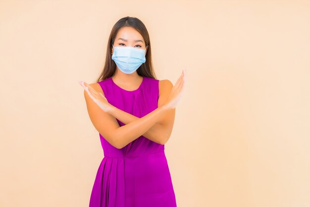 Portrait beautiful young asian woman wear mask for protect from covid19 or corona virus on color background