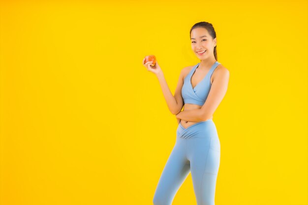 Portrait beautiful young asian woman wear sportwear ready for exercise on yellow