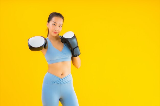 Portrait beautiful young asian woman wear sportwear on yellow