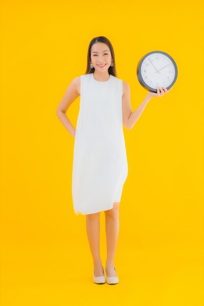 Portrait beautiful young asian woman with alarm or clock