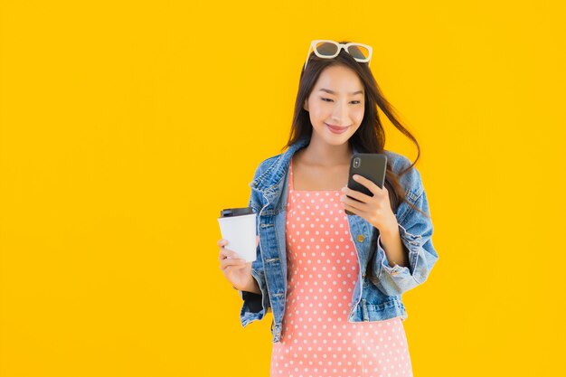 Portrait beautiful young asian woman with coffee cup and smartphone