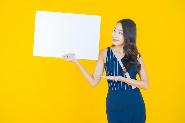 Portrait beautiful young asian woman with empty white billboard on