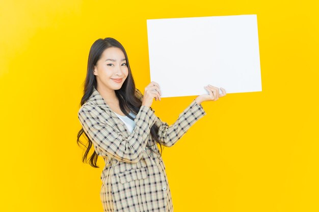 Portrait beautiful young asian woman with empty white placard