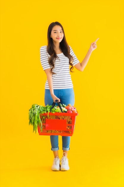 Portrait beautiful young asian woman with grocery basket cart from supermarket in shopping mall