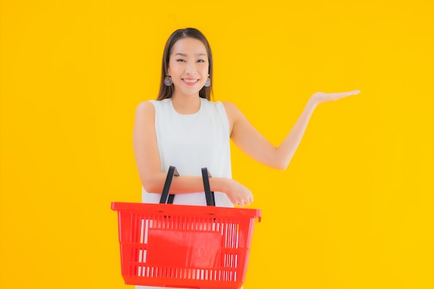 Free photo portrait beautiful young asian woman with grocery basket for shopping from supermarket