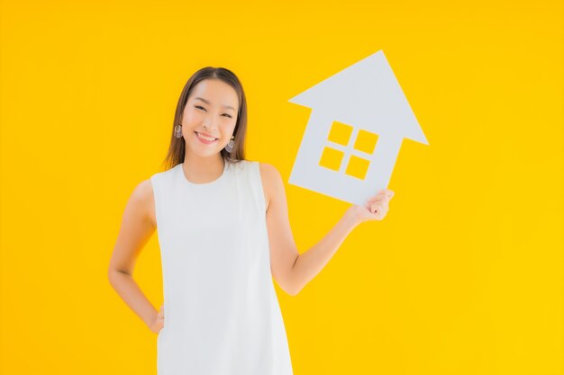 Portrait beautiful young asian woman with house paper