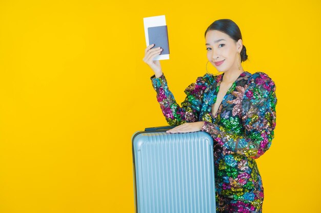 Portrait beautiful young asian woman with luggage bag and passport ready for travel