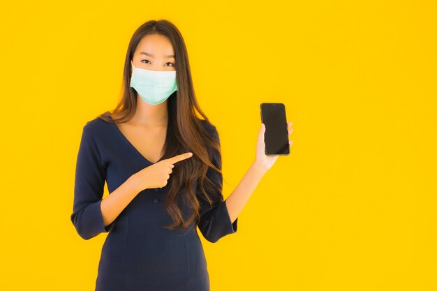 Portrait beautiful young asian woman with mask and phone