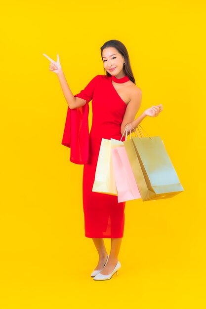 ショッピングバッグと肖像画の美しい若いアジアの女性