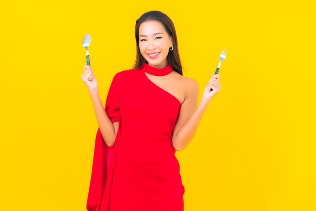 Portrait beautiful young asian woman with spoon and fork ready to eat