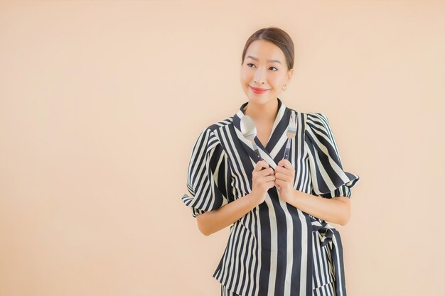 Portrait beautiful young asian woman with spoon and fork