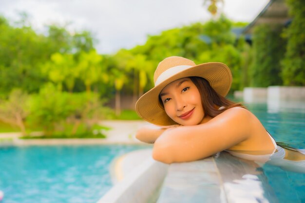 Portrait beautiful young asian women happy smile relax around outdoor swimming pool in hotel