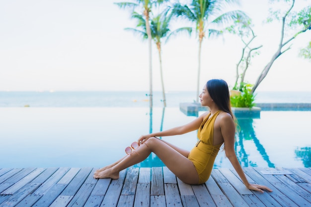 Portrait beautiful young asian women happy smile relax around outdoor swimming pool