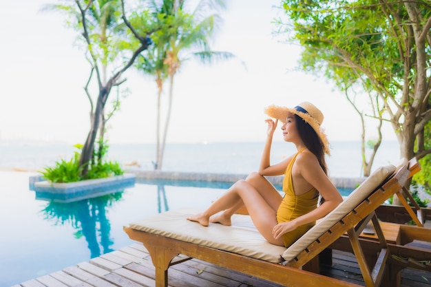 Portrait beautiful young asian women happy smile relax around outdoor swimming pool