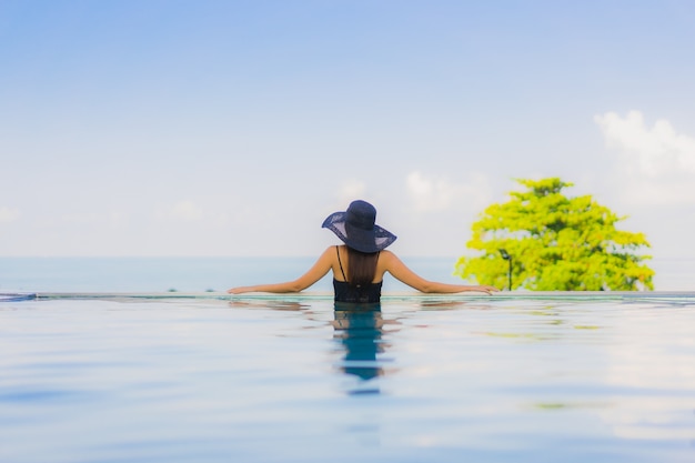 Portrait beautiful young asian women happy smile relax outdoor swimming pool in hotel