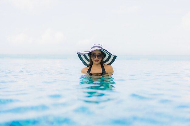 Portrait beautiful young asian women happy smile relax outdoor swimming pool in resort