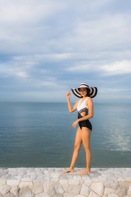 Portrait beautiful young asian women relax smile happy around sea beach ocean