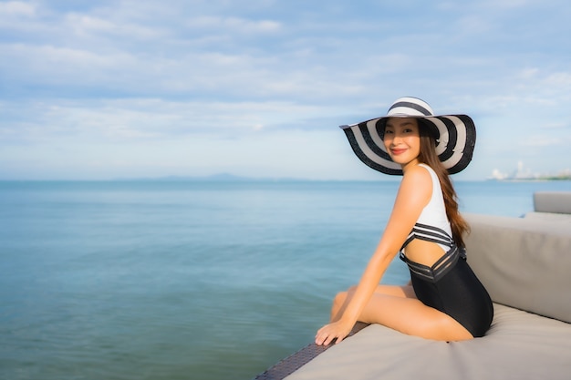 Portrait beautiful young asian women relax smile happy around sea beach ocean