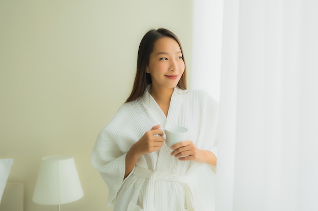 침실에서 커피 컵 초상화 아름 다운 젊은 아시아 여성