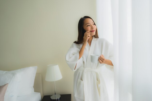 Portrait beautiful young asian women with coffee cup and mobile phone