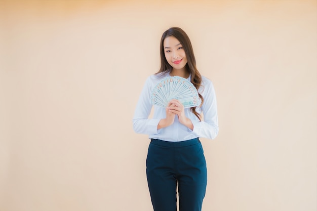 Portrait beautiful young business asian woman with cash or money