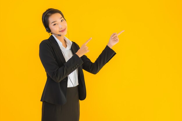 Portrait beautiful young business asian woman with headphone or headset