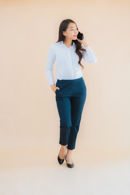 Portrait beautiful young business asian woman with smart mobile phone and coffee cup