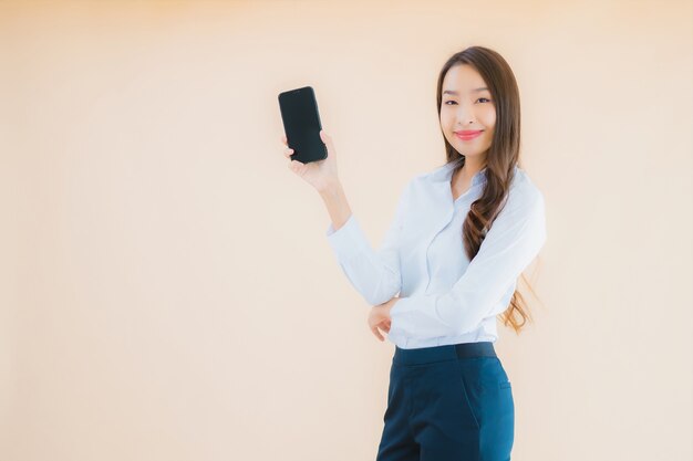 Portrait beautiful young business asian woman with smart mobile phone and coffee cup