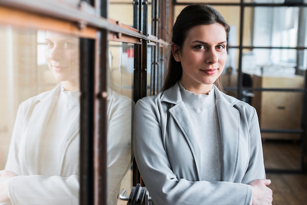 Portrait of beautiful young businesswoman with arm crossed