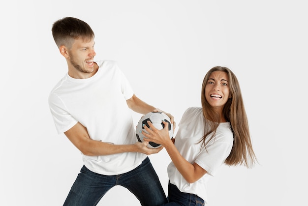 Free photo portrait of beautiful young couple football or soccer fans on white studio