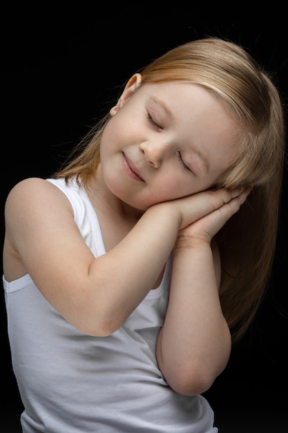 Portrait of beautiful young girl with short fair hair wants to sleep