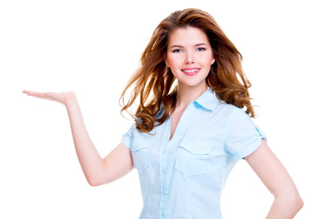 Portrait of beautiful young happy woman holds something on palm - isolated