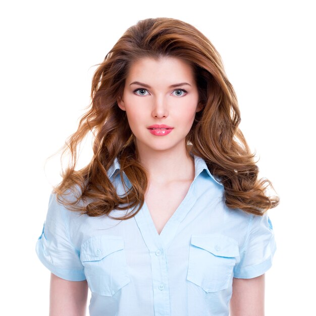 Portrait of a beautiful young smiling woman in blue shirt  isolated