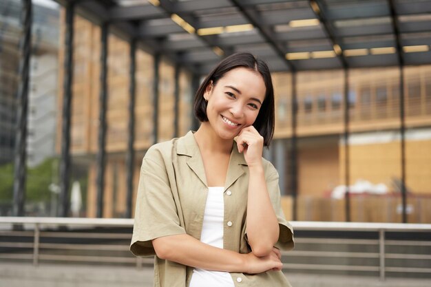 Portrait of beautiful young woman in casual clothes smiling posing outdoors on an empty street near