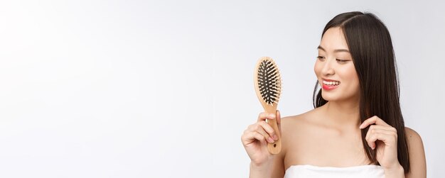 Portrait of a beautiful young woman comb wonderful hair isolated on white background asian beauty