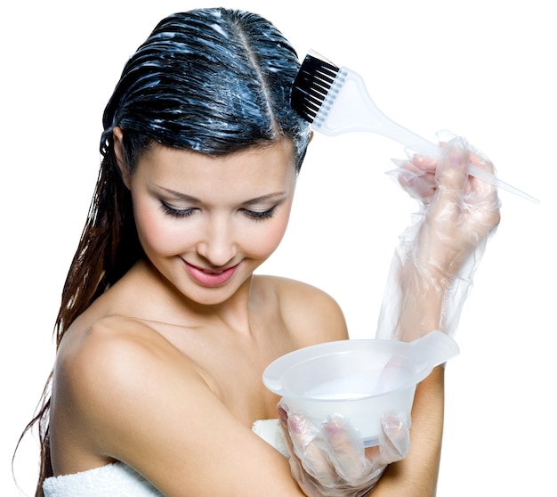 Free photo portrait of beautiful young woman dyeing hairs isolated on white