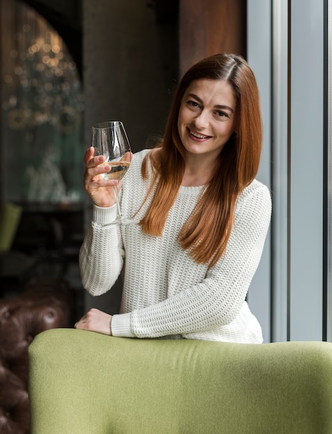 Portrait of beautiful young woman having wine