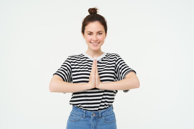 Free photo portrait of beautiful young woman holds hands together namaste gesture say thank you expresses