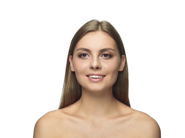 Portrait of beautiful young woman isolated on white  wall. Caucasian healthy female model looking at camera and posing. Concept of women's health and beauty, self-care, body and skin care.