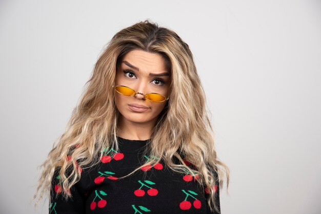 Portrait of a beautiful young woman posing in glasses. 