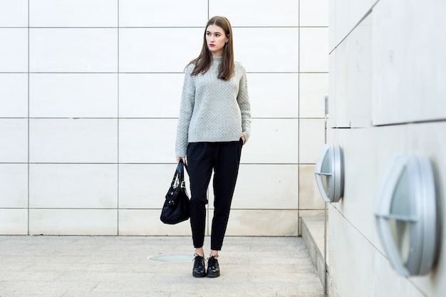 Portrait of beautiful young woman posing in the street.