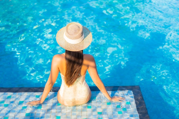 Portrait of beautiful young woman relaxing at the swimming pool